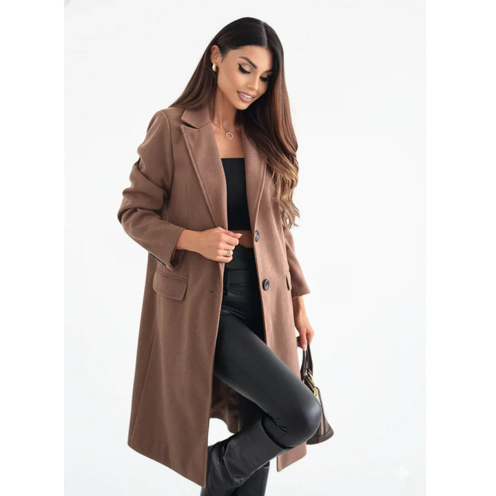 Woman wearing stylish brown wool coat, black top, and leather pants on white background