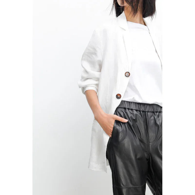 Woman wearing black genuine leather pants and white blazer, Rovelli fashion style