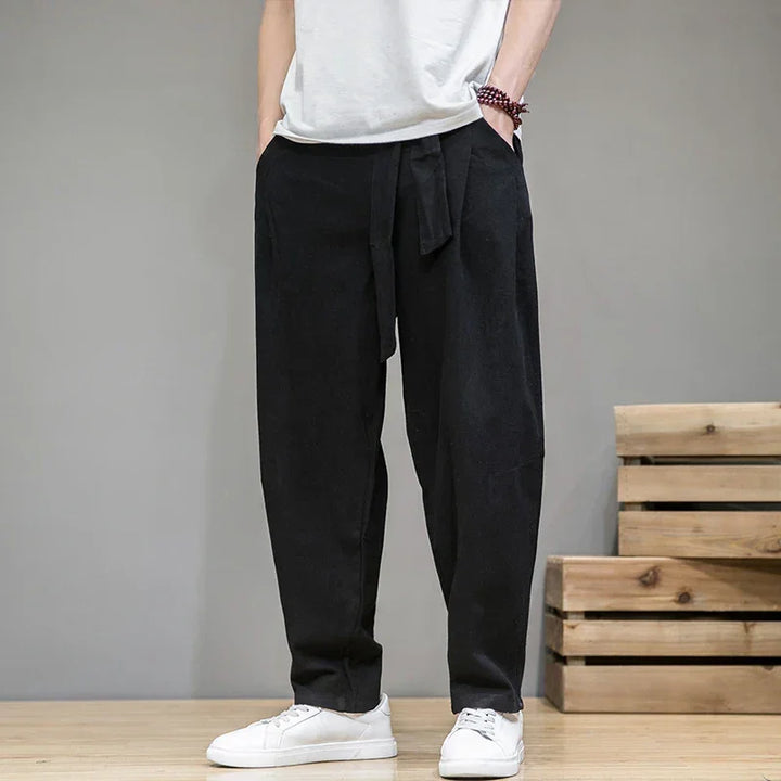 Rovelli casual black drawstring pants with white sneakers, relaxed modern style