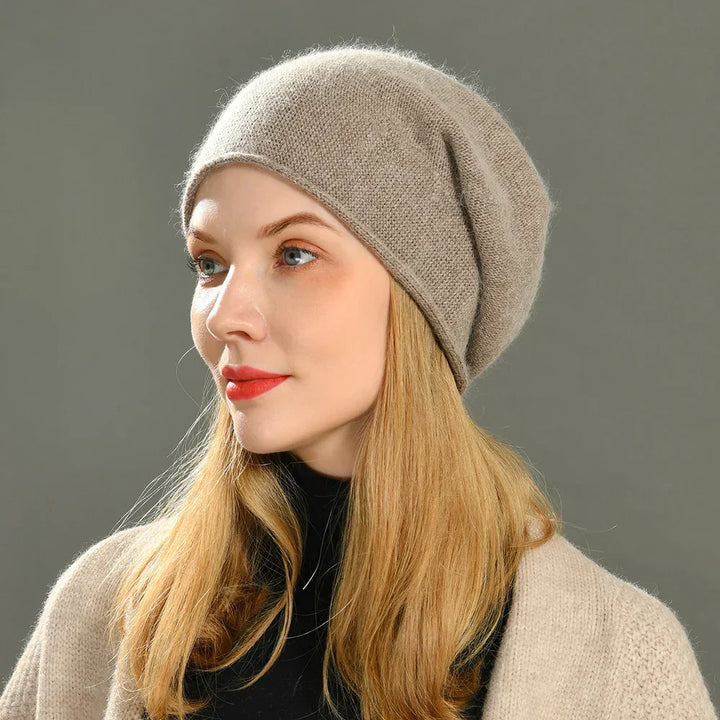 Woman wearing beige knit beret hat, Rovelli fashion, neutral background