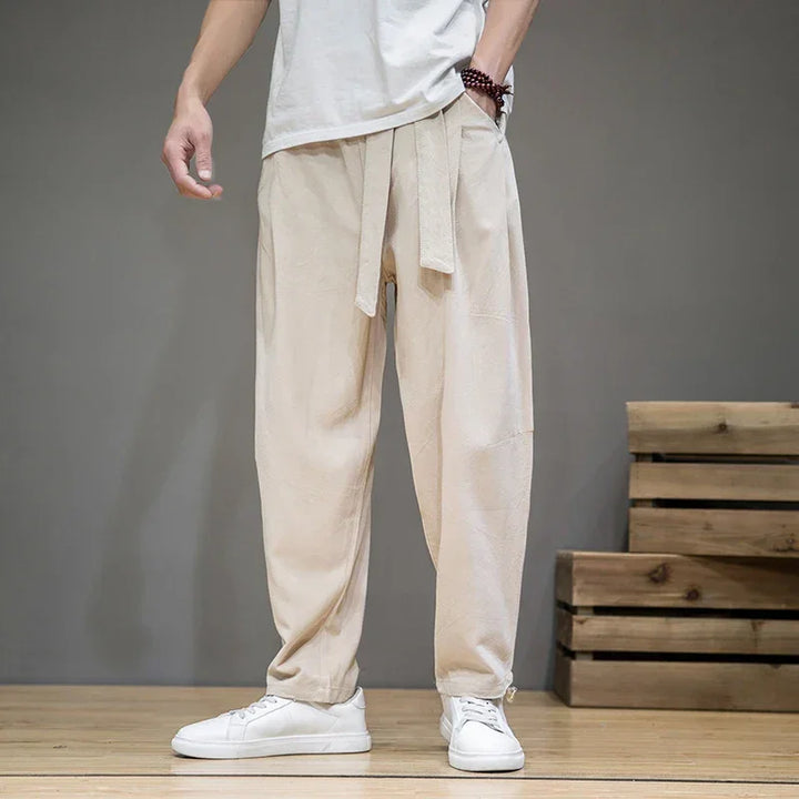 Rovelli beige casual pants with waist tie, worn with white sneakers, modern indoor setting