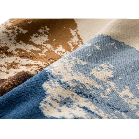 Close-up of Rovelli patterned rug with abstract blue and brown design