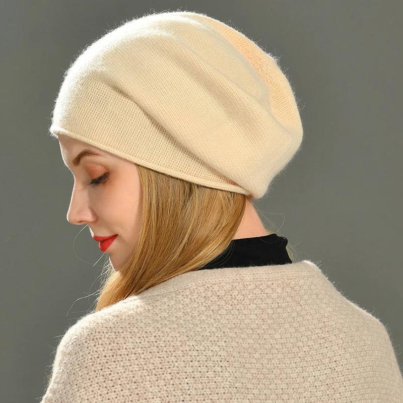 Woman wearing a cream knit beanie and sweater, Rovelli cozy winter fashion