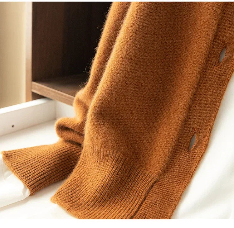 Soft brown knit cardigan with buttonholes draped on white surface, Rovelli fashion