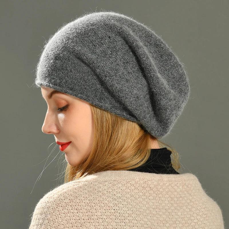 Woman wearing a soft gray knit beret, side profile, Rovelli fashion accessory