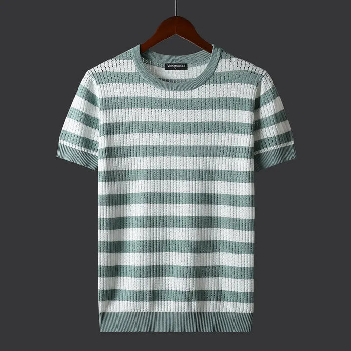 A short-sleeved, comfort-fit ribbed knit sweater with horizontal light green and white stripes, displayed on a wooden hanger against a dark gray background.