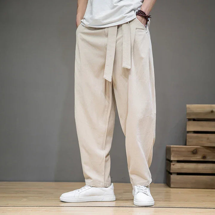Rovelli beige loose linen pants with drawstring waist, styled with white sneakers