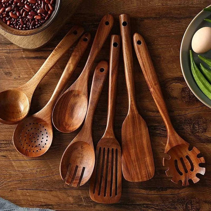 Rovelli wooden kitchen utensils set on rustic wooden table with beans and vegetables