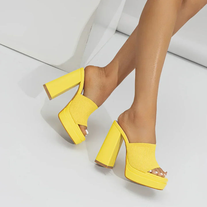 Rovelli yellow block heel sandals on model, open toe, platform design, white background