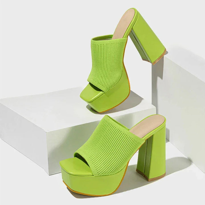 Lime green platform sandals with chunky heels and ribbed texture, displayed on white blocks, Rovelli