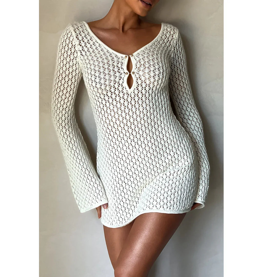 Woman wearing Rovelli white crochet knit mini dress with long sleeves and keyhole neckline