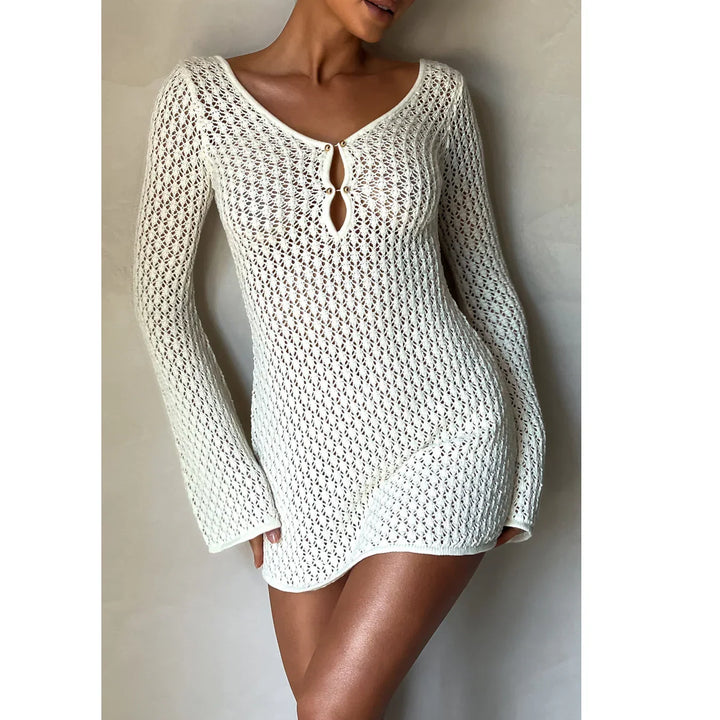 Woman wearing Rovelli white crochet knit mini dress with long sleeves and keyhole neckline