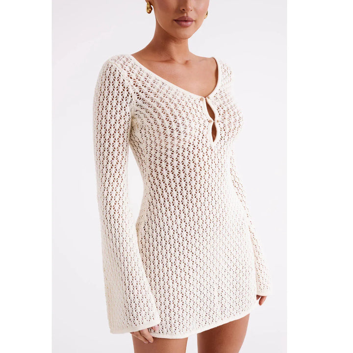 Woman wearing cream crochet knit mini dress with long sleeves, Rovelli fashion