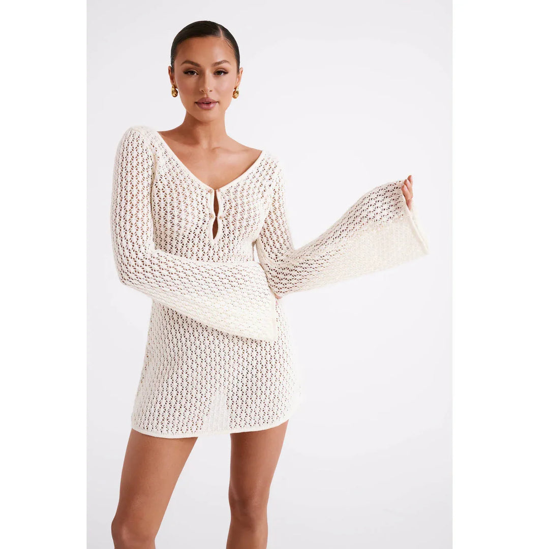 Woman modeling cream crochet mini dress with bell sleeves by Rovelli