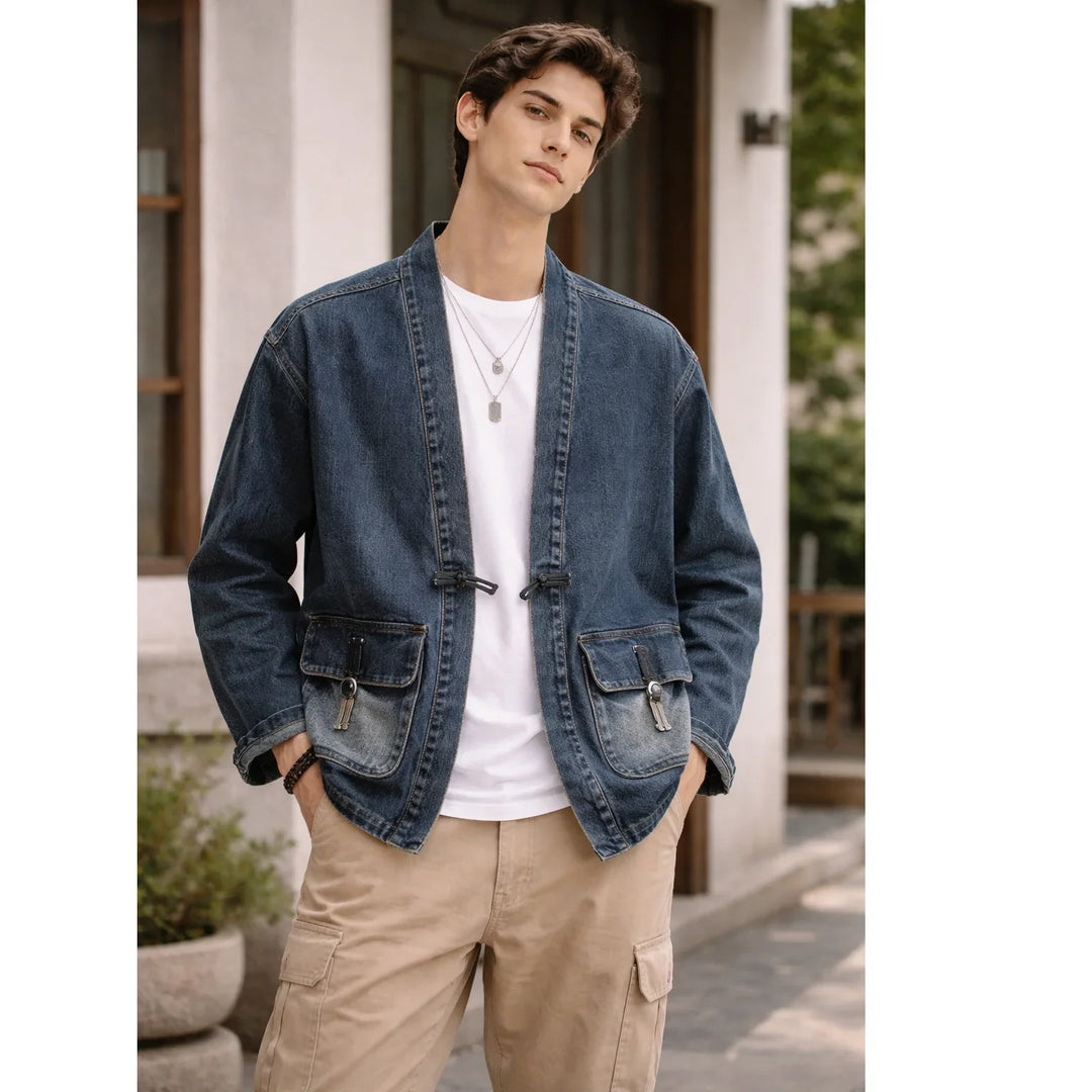 Man wearing blue denim kimono jacket from Rovelli, white shirt, tan pants, outdoors