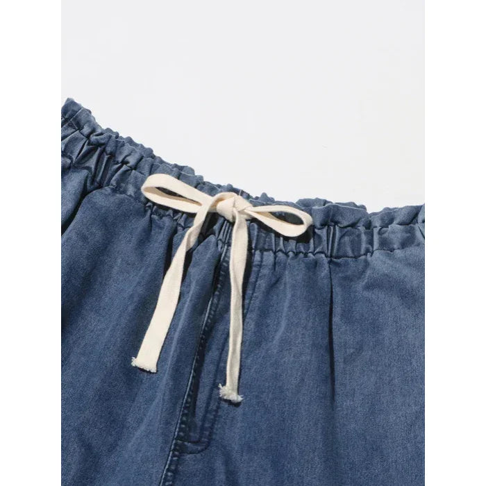 Rovelli blue denim jeans with white drawstring waistband, close-up view