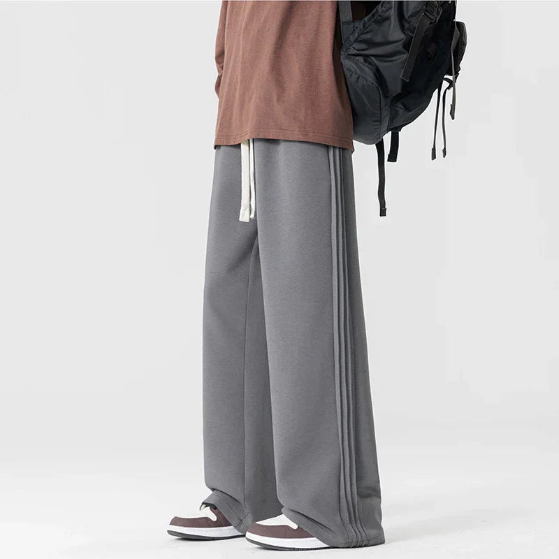 Rovelli wide leg gray sweatpants with side stripes, drawstring, and sneakers