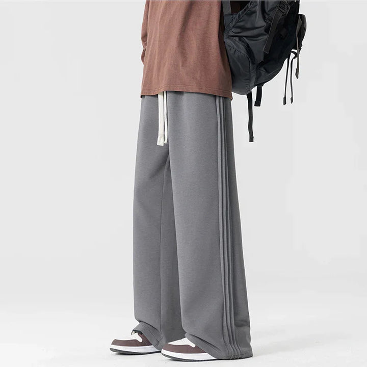 Rovelli wide leg gray sweatpants with side stripes, drawstring, and sneakers