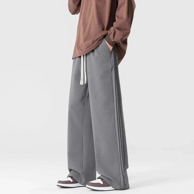 Rovelli wide-leg gray sweatpants with white drawstring, paired with brown top and sneakers