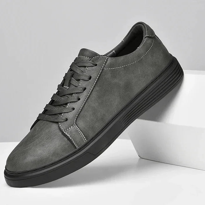 Rovelli stylish gray men's sneaker with black sole and white stitching on display