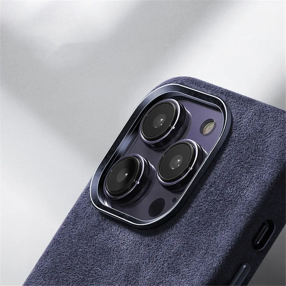 Close-up of the rear camera module of a smartphone with three lenses, shown in a dark blue textured case featuring a suede finish against a light background.