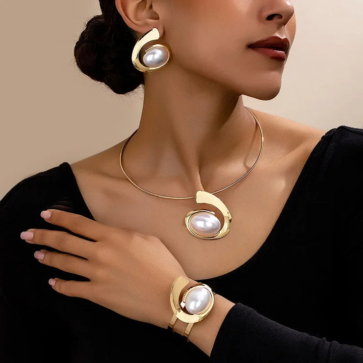 Woman wearing Rovelli gold jewelry set with pearl earrings, necklace, and bracelet
