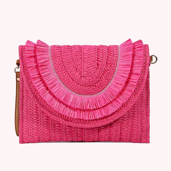 Rovelli pink woven clutch bag with fringe flap design on white background