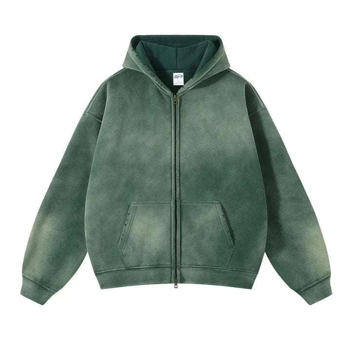 A green zip-up hoodie with a spray-dyed vintage wash effect. This relaxed fit style features thickened fabric, a front zipper, large pockets, ribbed cuffs and hem, and a drawstring hood for added comfort.