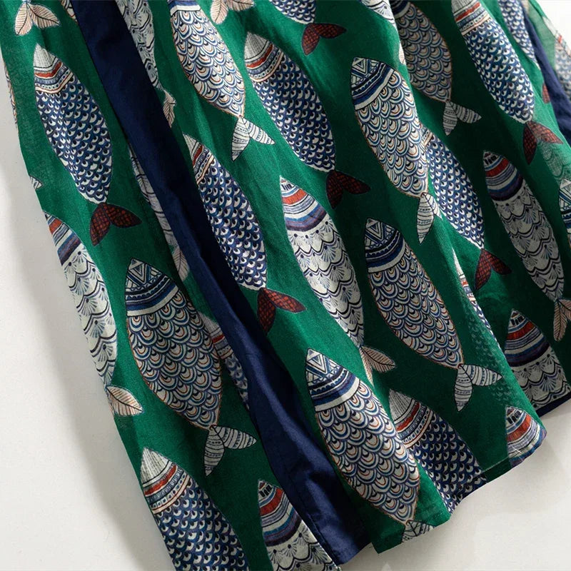 Rovelli green skirt with colorful fish print pattern on fabric