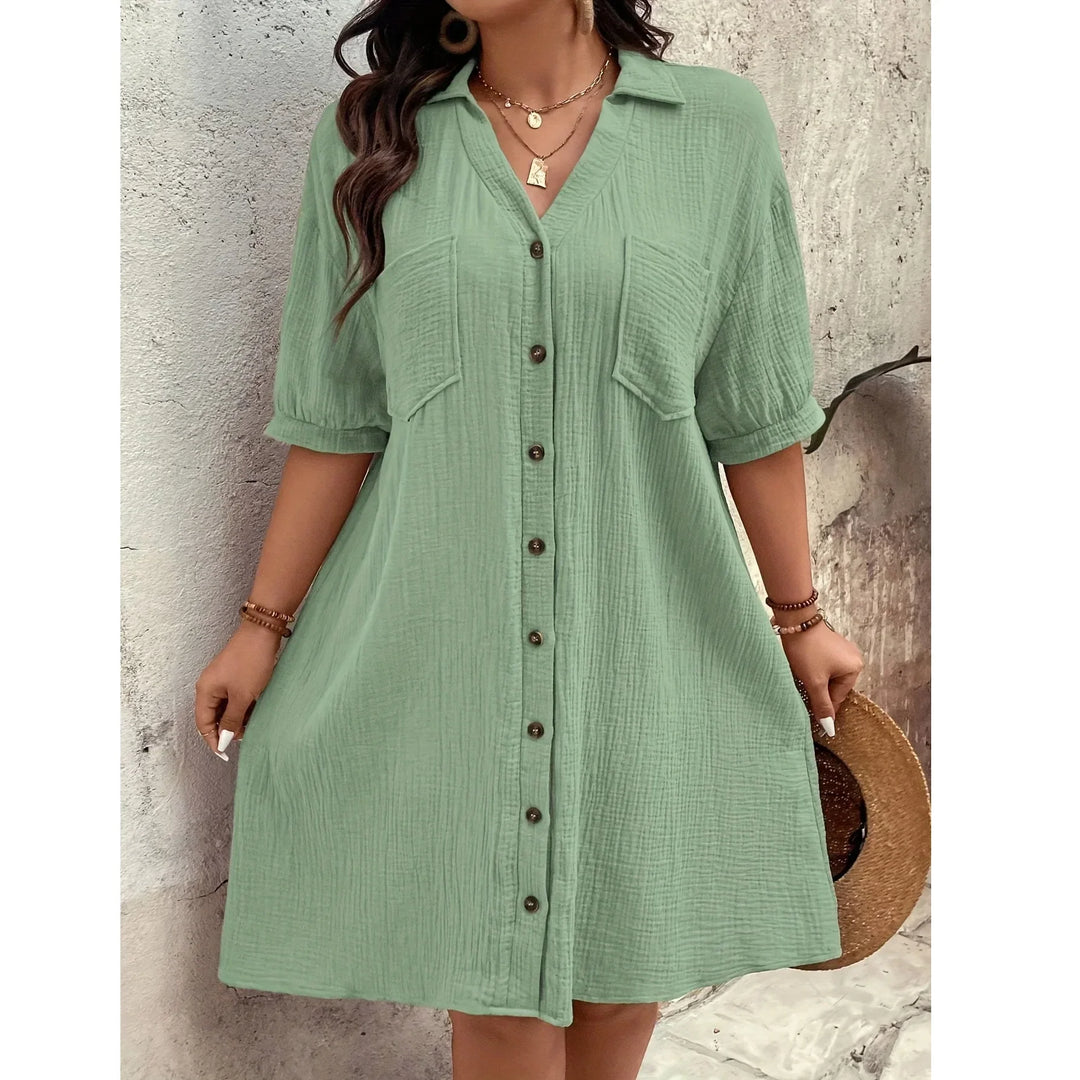 Woman wearing light green button-down shirt dress with pockets, outdoor summer style
