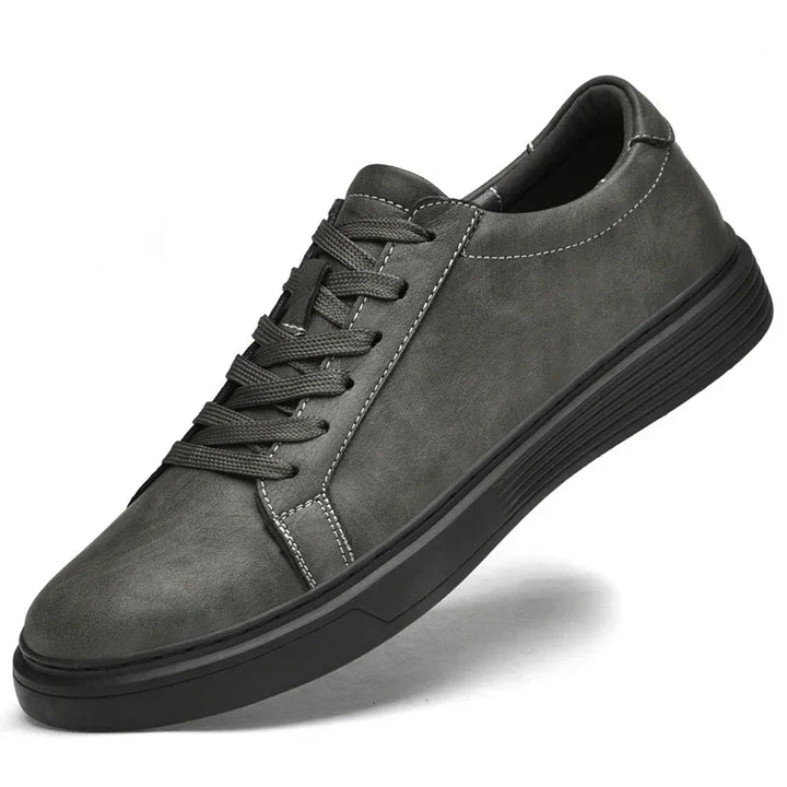 Rovelli men's grey casual sneaker with black sole and white stitching, side view