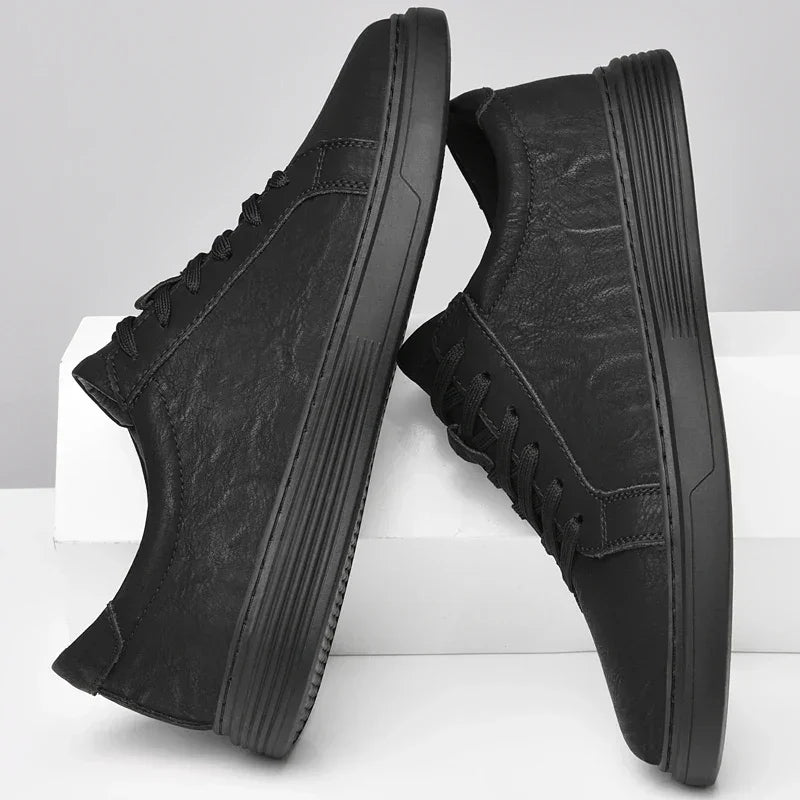 Rovelli classic black low-top sneakers with textured finish and rubber soles on white background