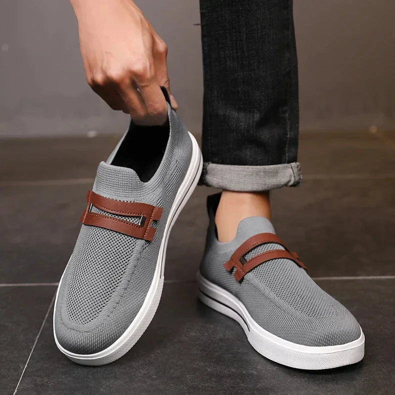 Rovelli gray slip-on mesh sneakers with brown strap detail, worn with rolled jeans