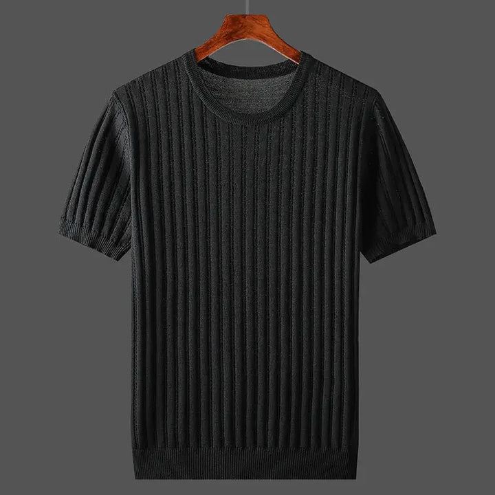 A black, short-sleeve, ribbed knit sweater with a classic fit is displayed on a wooden hanger against a plain gray background.