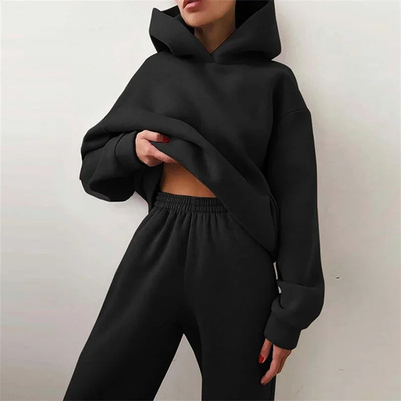 Woman wearing black hoodie and sweatpants loungewear set, Rovelli fashion
