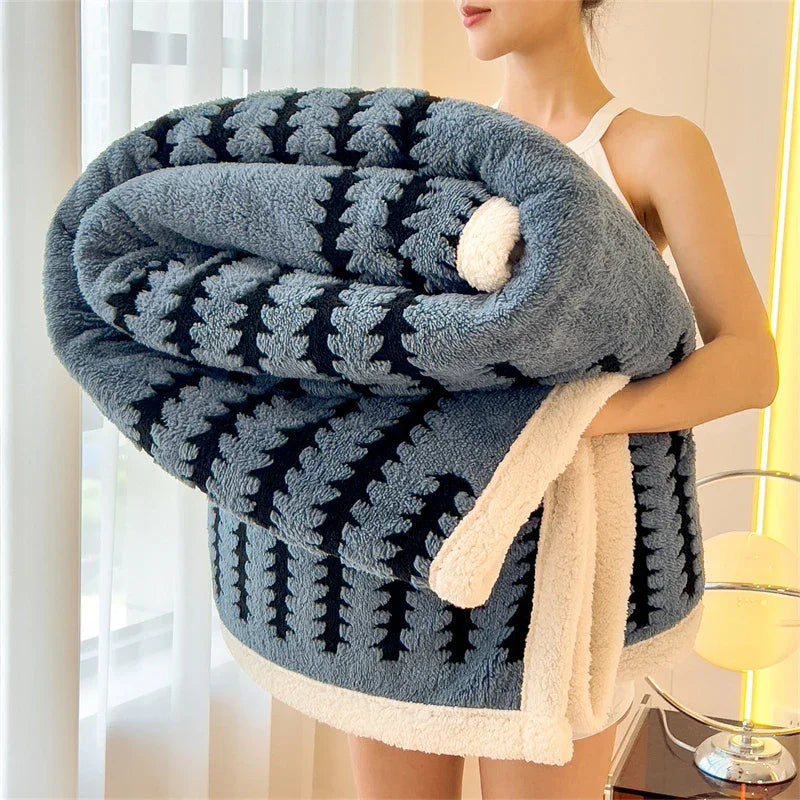 Woman holding large blue and black patterned fluffy blanket with white trim, Rovelli home decor