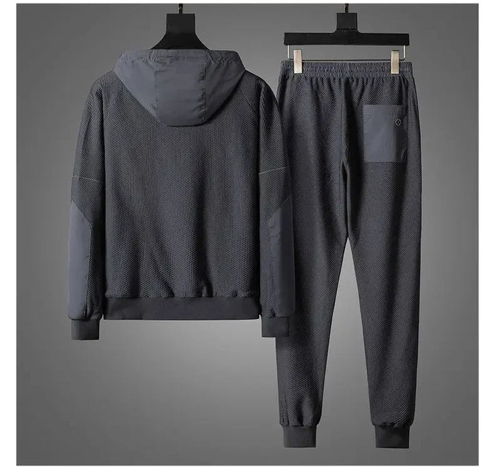 A stylish activewear set featuring a jacket and pants on a swinger, perfect for comfort and mobility.