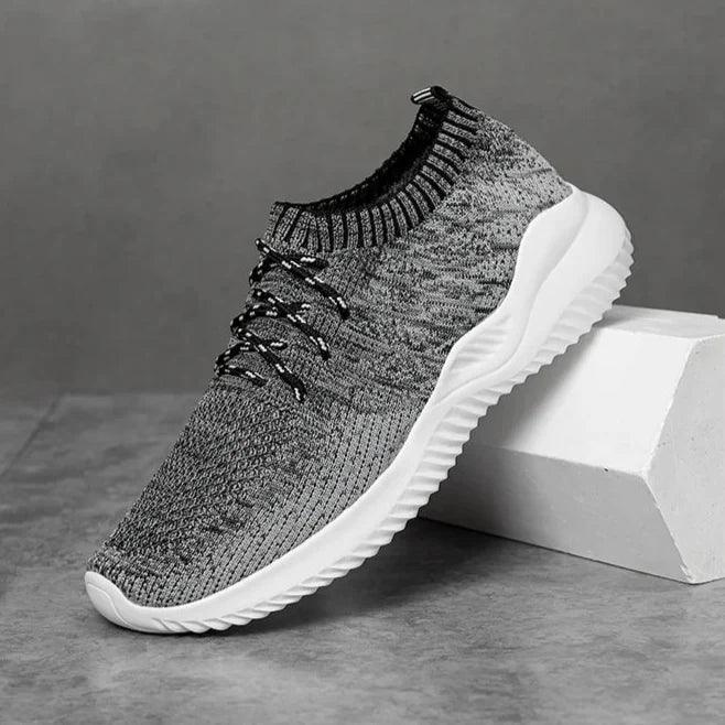 Rovelli lightweight gray knit sneaker with white sole on gray background