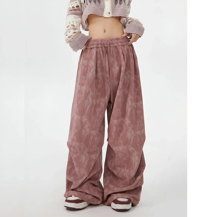 Rovelli model wearing wide leg pink tie dye corduroy pants and cropped knit sweater