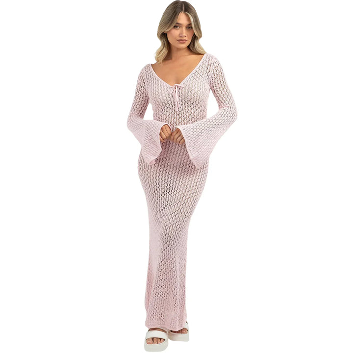 Woman wearing light pink crochet knit maxi dress with bell sleeves from Rovelli