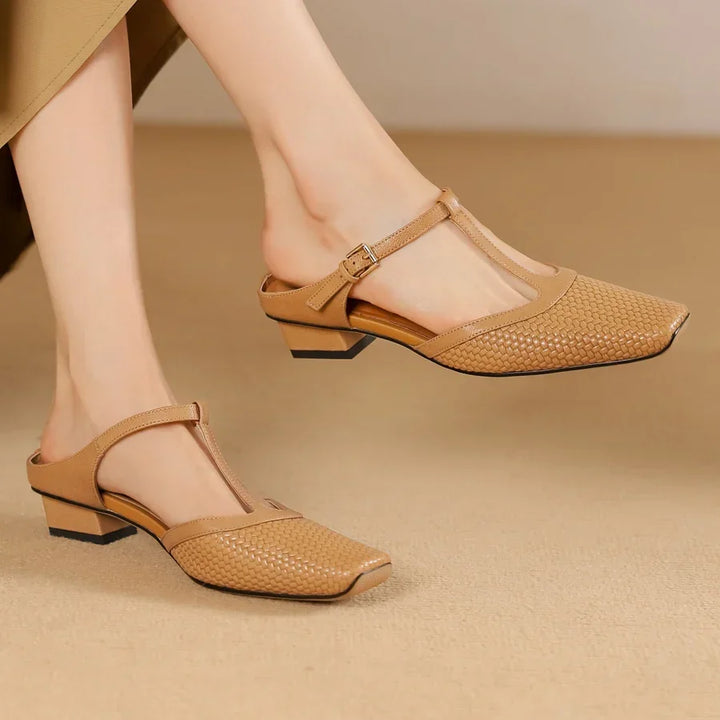 Rovelli tan woven leather T-strap block heel mules on model feet