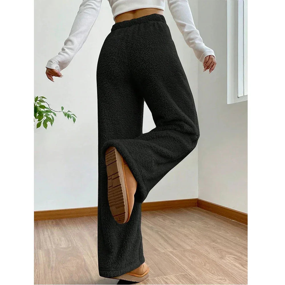 Rovelli black fleece wide-leg pants, cozy loungewear, modeled indoors on wood floor