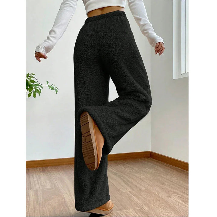 Rovelli black fleece wide-leg pants, cozy loungewear, modeled indoors on wood floor