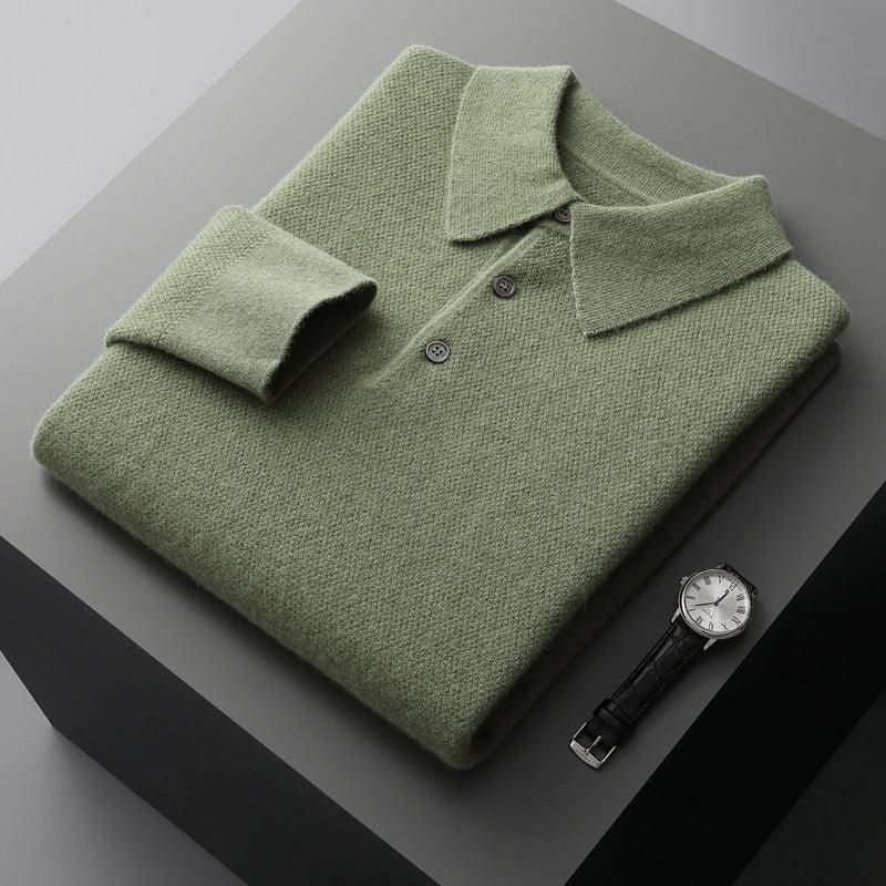 Folded sage green knit polo sweater with buttons beside a classic wristwatch on a gray table, Rovelli