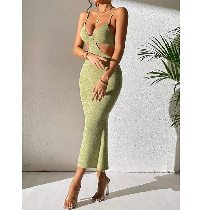 Woman in green cutout bodycon dress with spaghetti straps, posing indoors near plant, Rovelli fashion