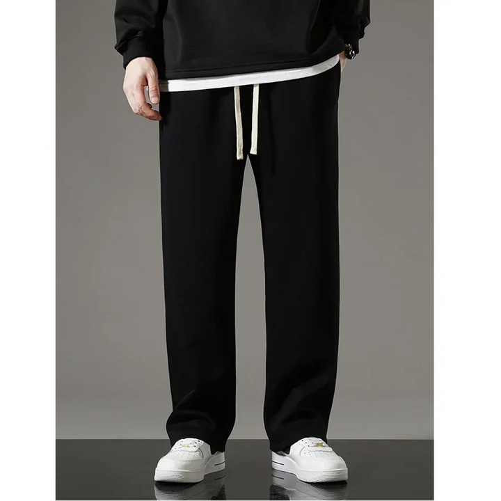 Rovelli black casual pants with drawstring and white sneakers on a model