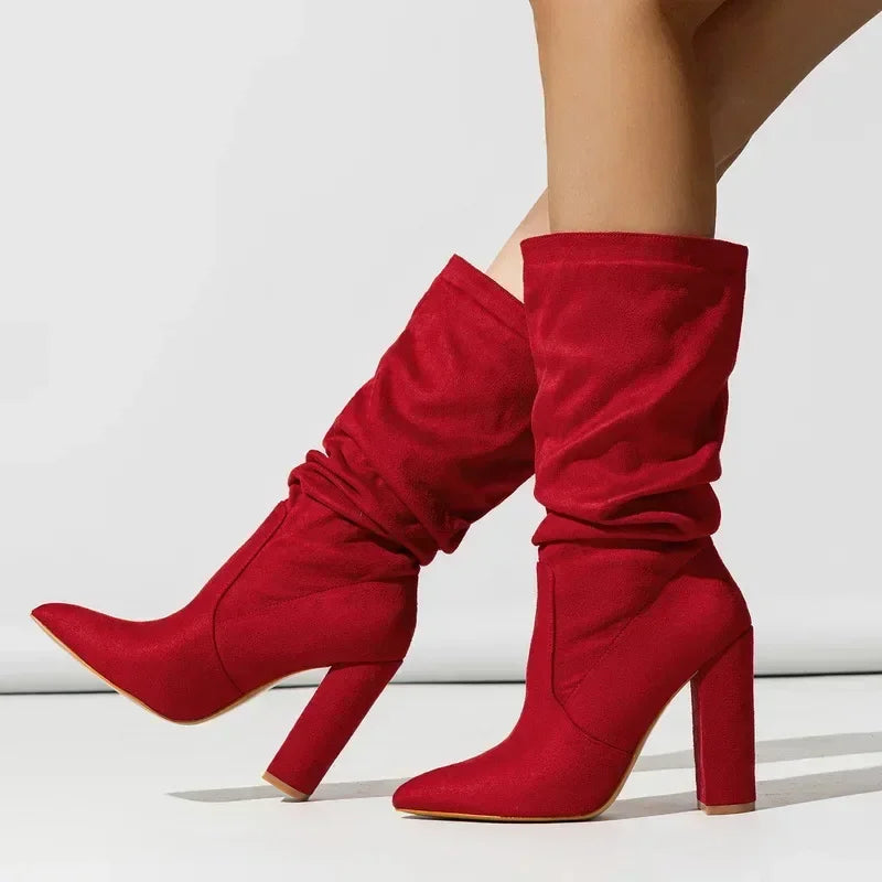 Red suede high-heel boots with pointed toe from Rovelli, worn by a model, white background
