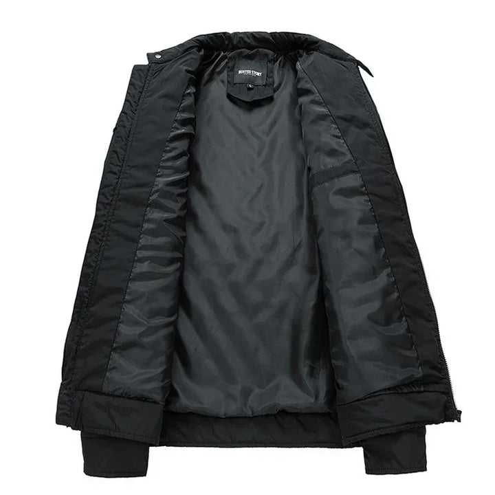 Black slim-fit jacket displayed open to show its smooth, dark inner lining, with ribbed cuffs and a collar. Lightweight and wind-resistant, it’s perfect for casual, everyday wear.
