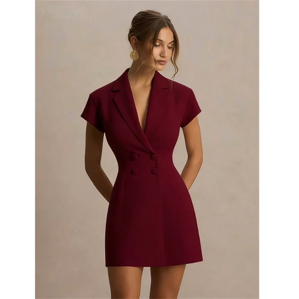 Woman wearing a burgundy double-breasted blazer dress by Rovelli against a neutral background