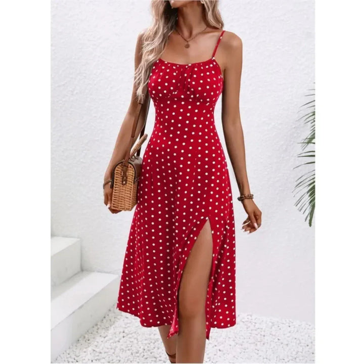 Woman in a red polka dot summer dress with slit, holding wicker bag, Rovelli fashion